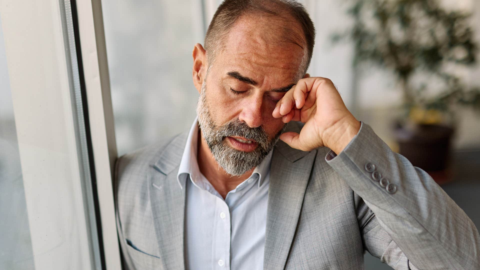 Man struggling with perfectionism at work.