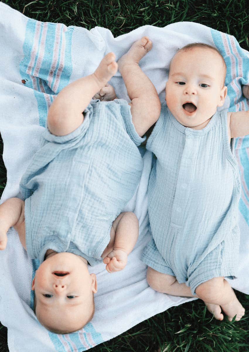 infant newborn babies laying in grass