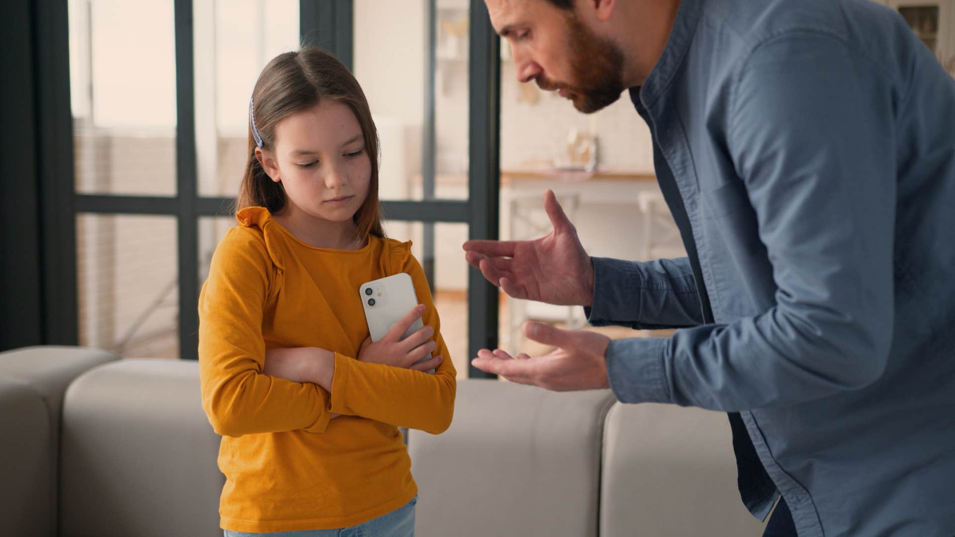 dad talking to little girl with a phone not teaching her delayed gratification