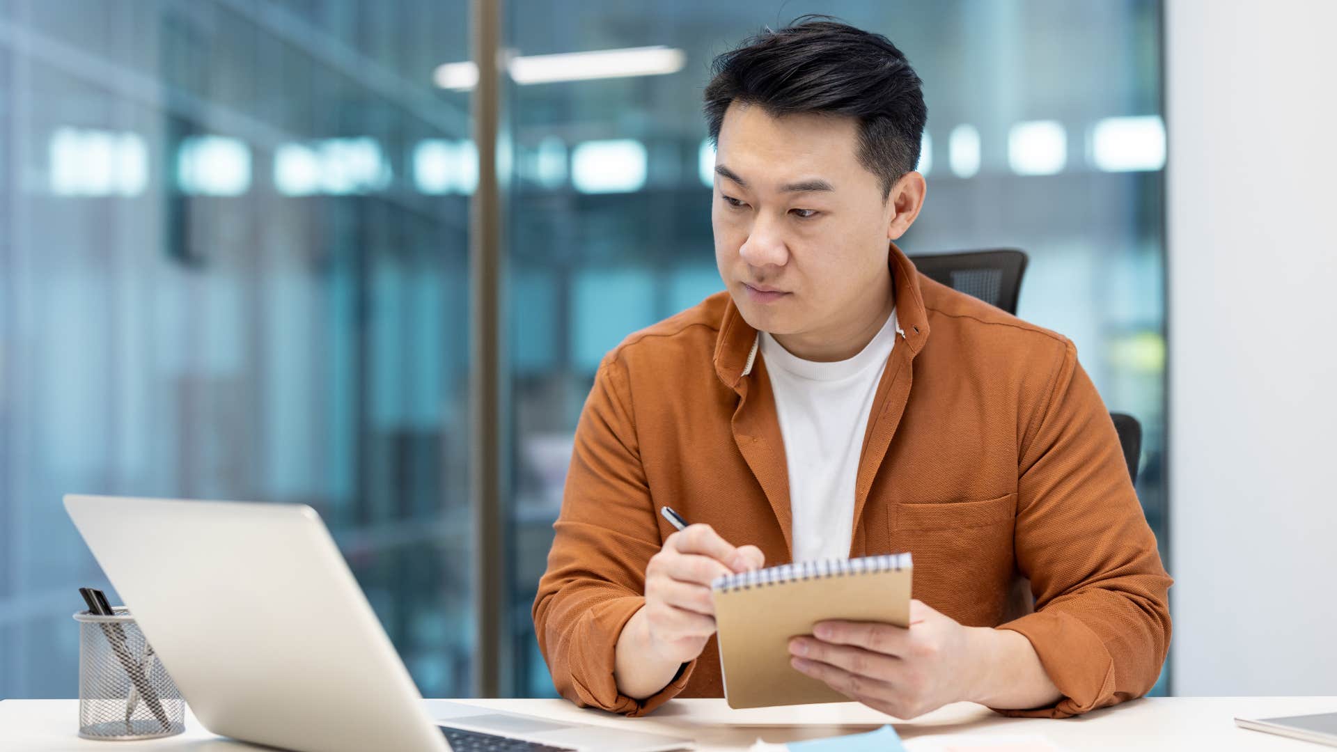 man working noticing patterns on his laptop
