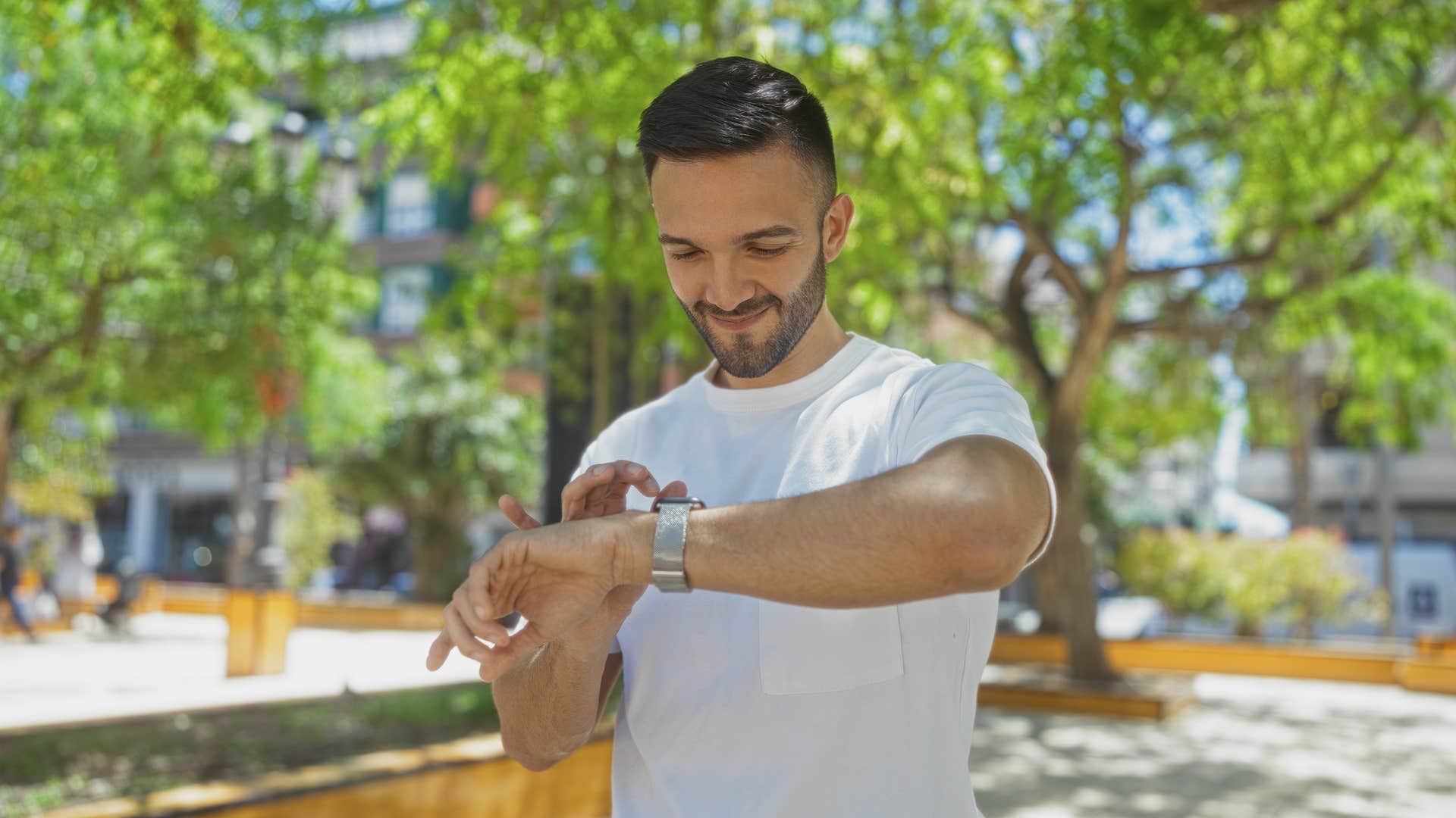 man looking at watch accepting delayed gratification