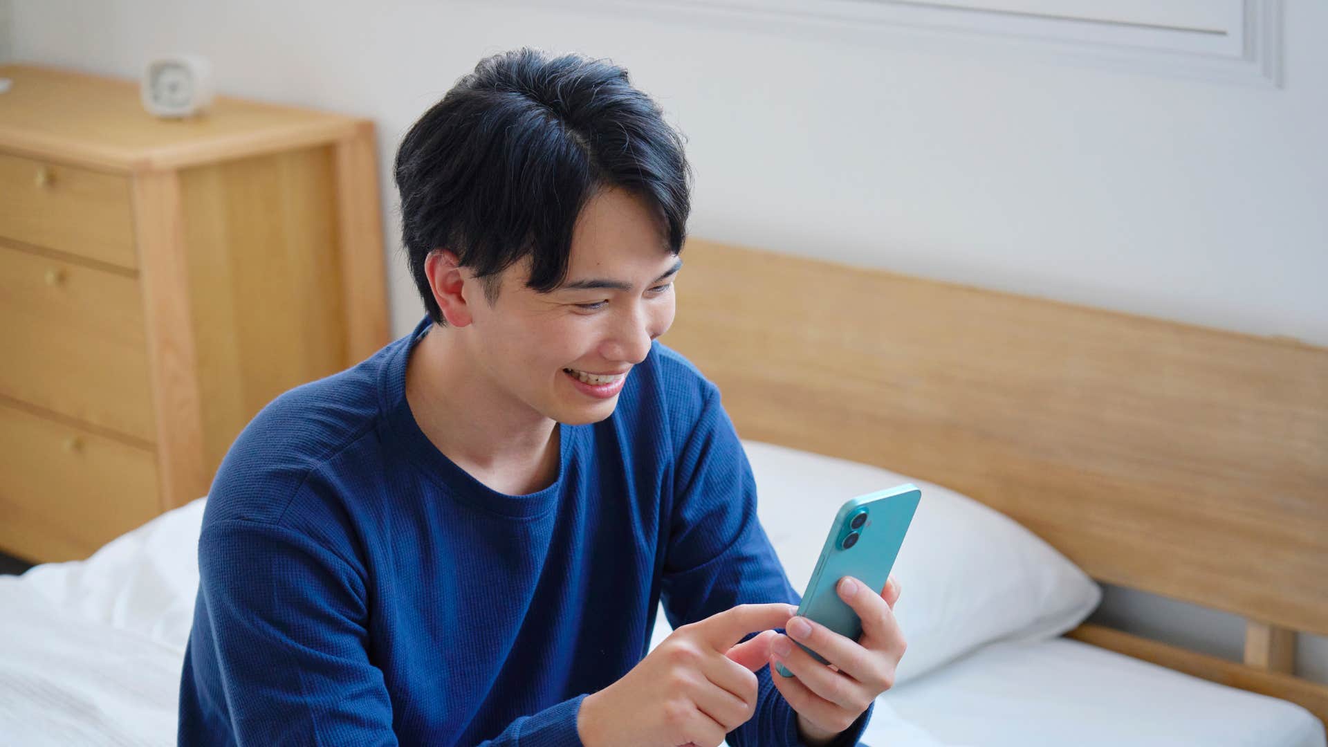 man looking at phone to learn new things