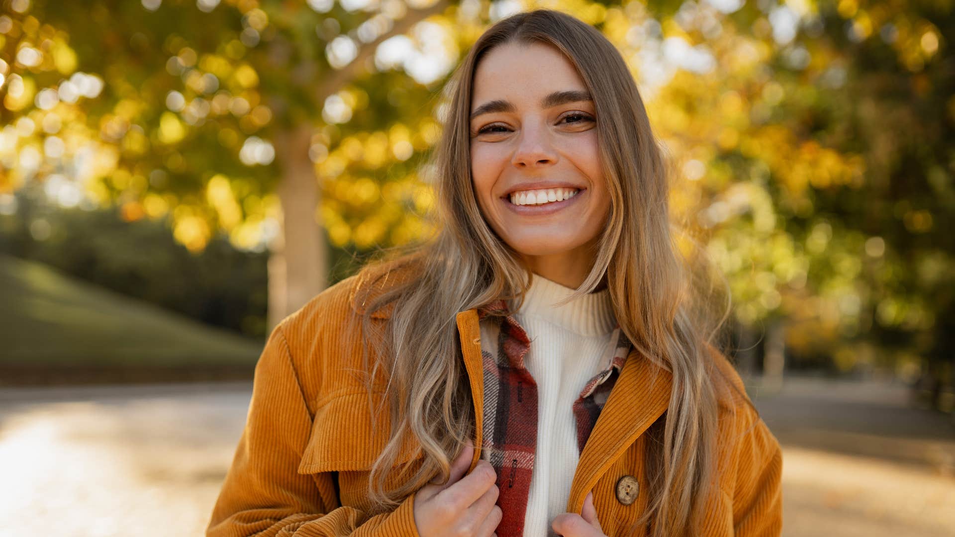 happy woman who grew up in the 90s smiling outside