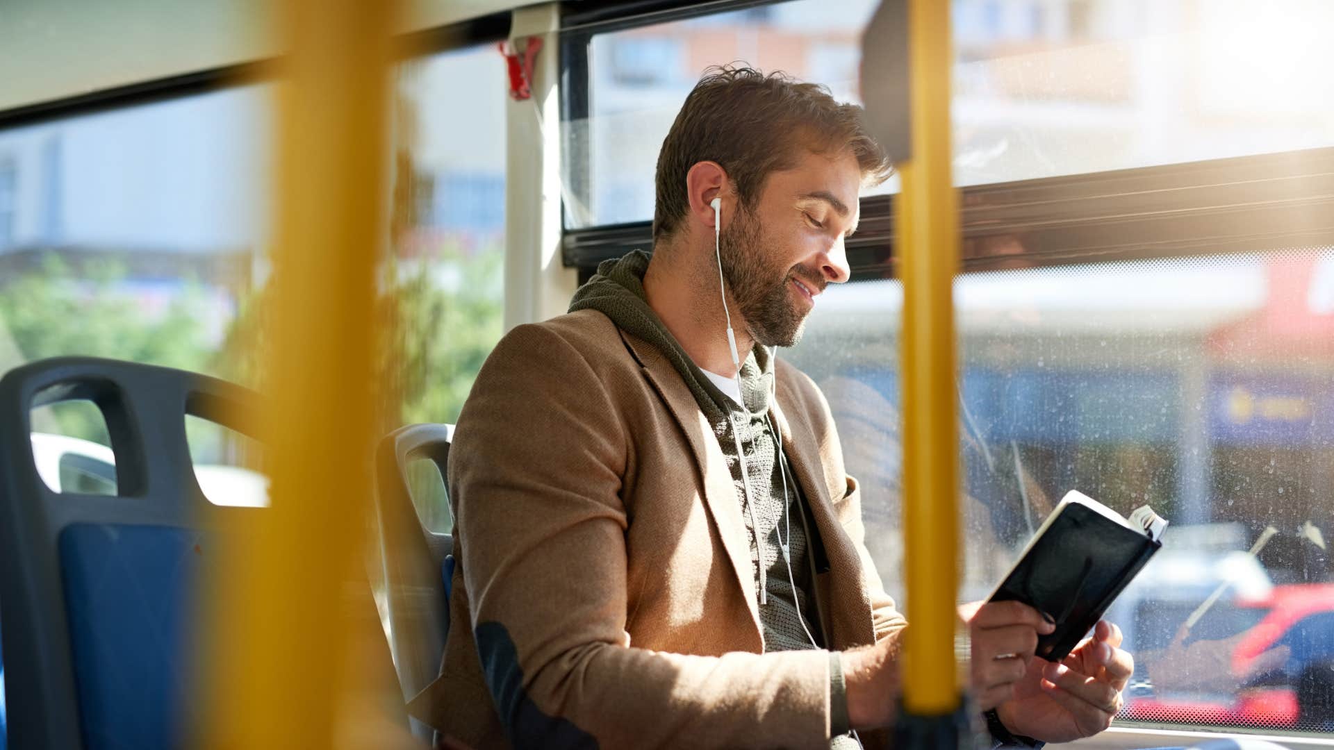 man on bus reading to memorize