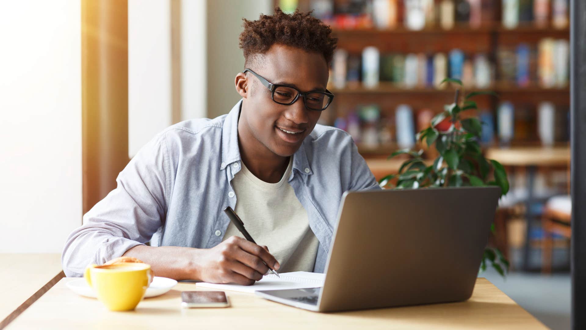 man who plays video games working on laptop