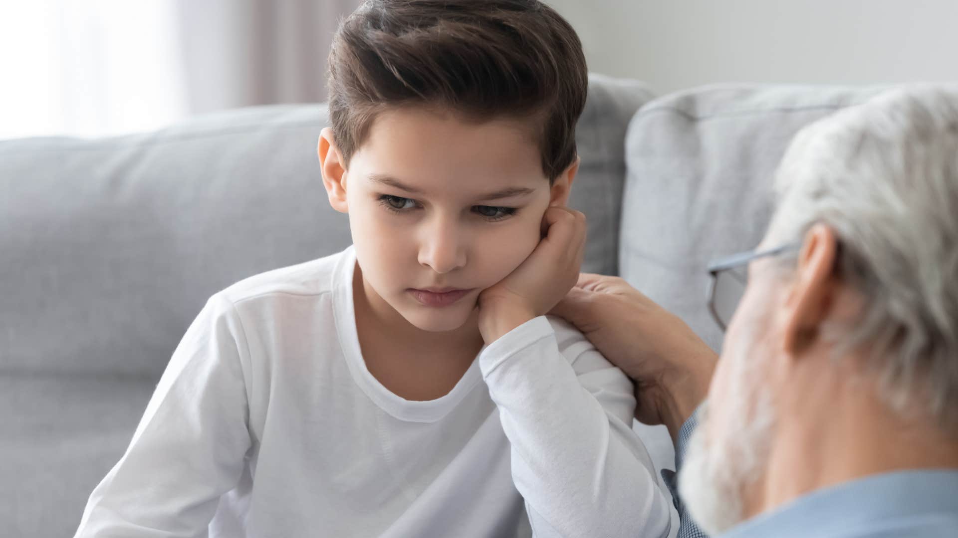 little boy accepting feedback and correction from family member