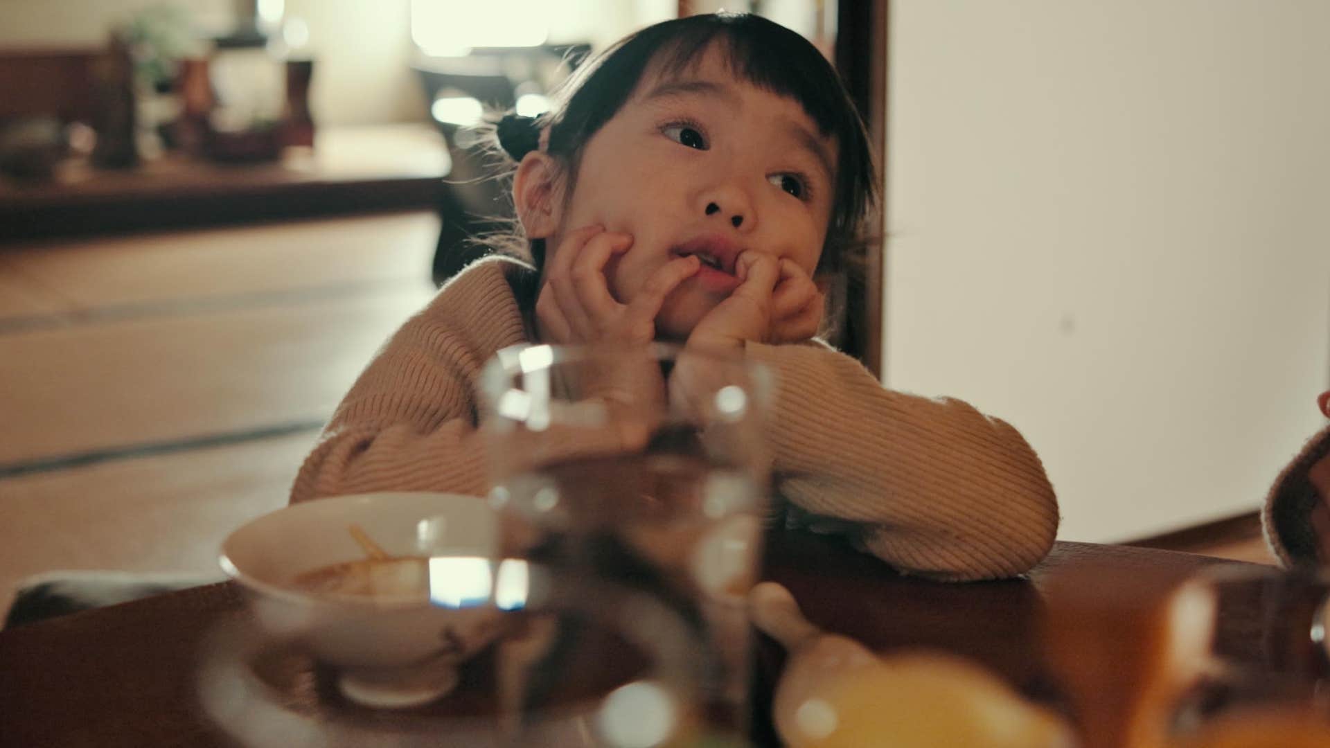 little boy coping with not having instant gratification at the dinner table