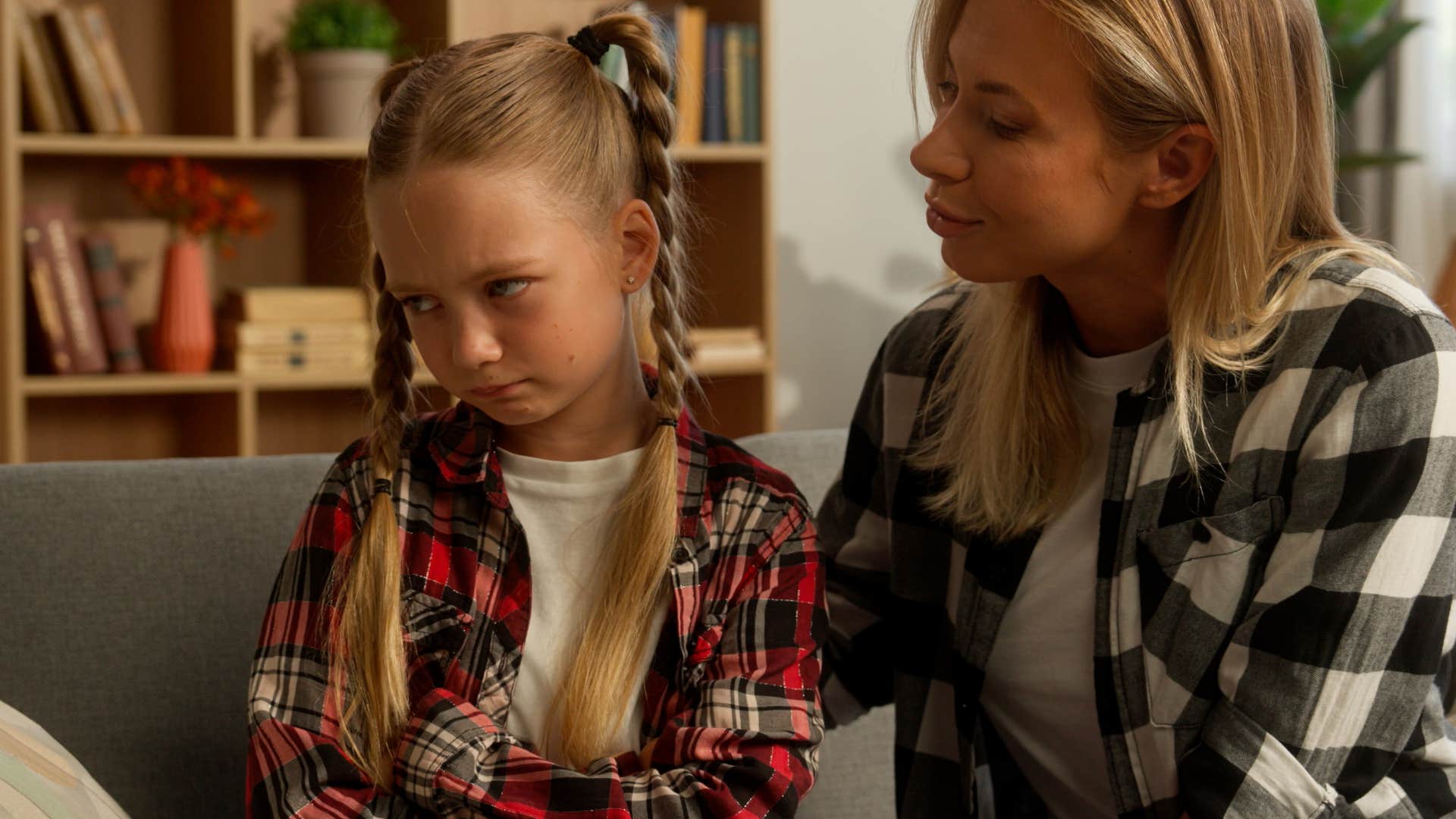 little girl being taught not to blame others for her mistakes