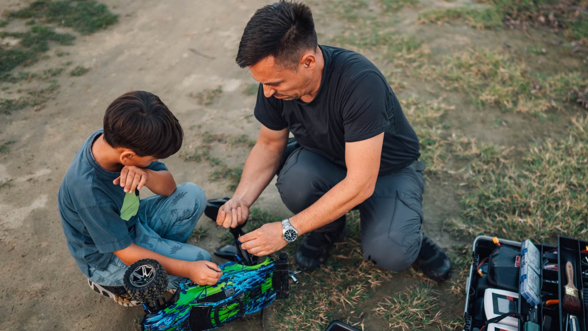 dad teaching son how to fix things before replacing them