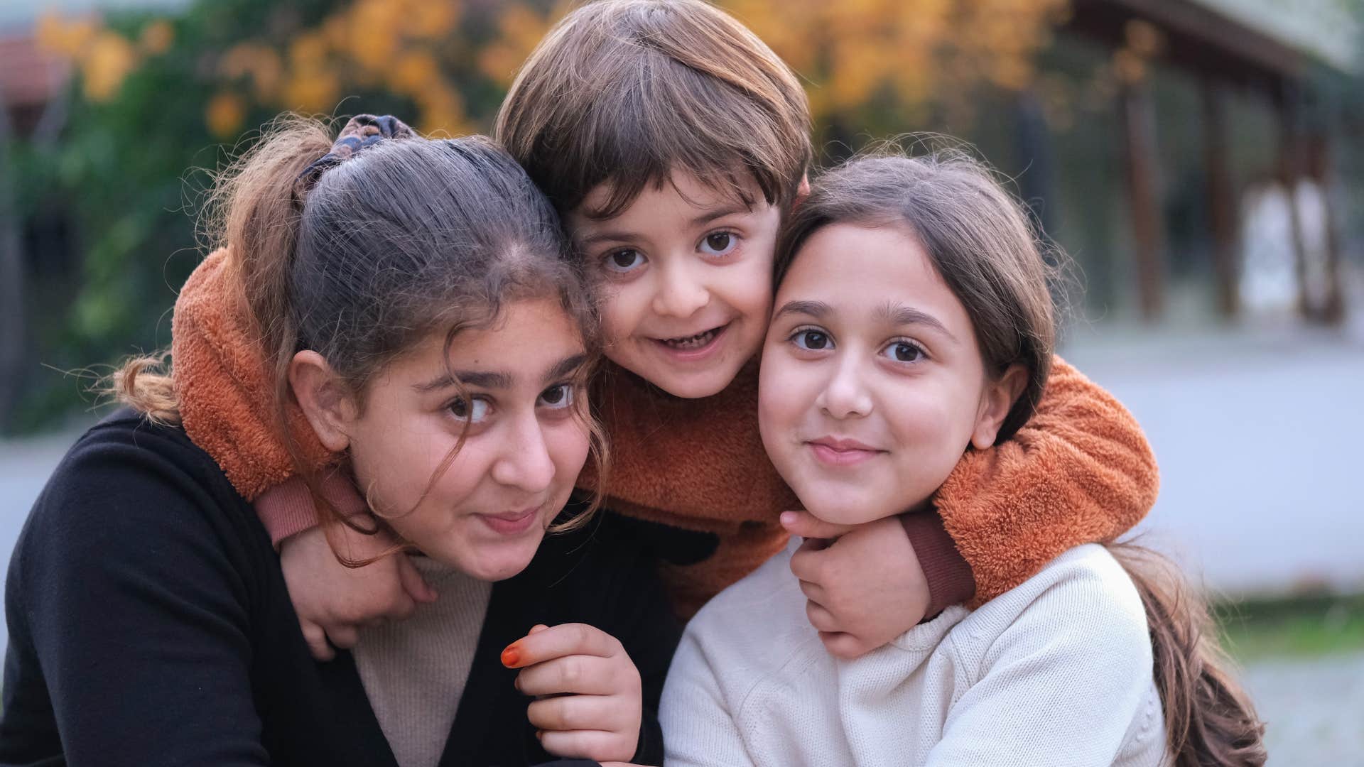 older daughter helping to care for younger siblings