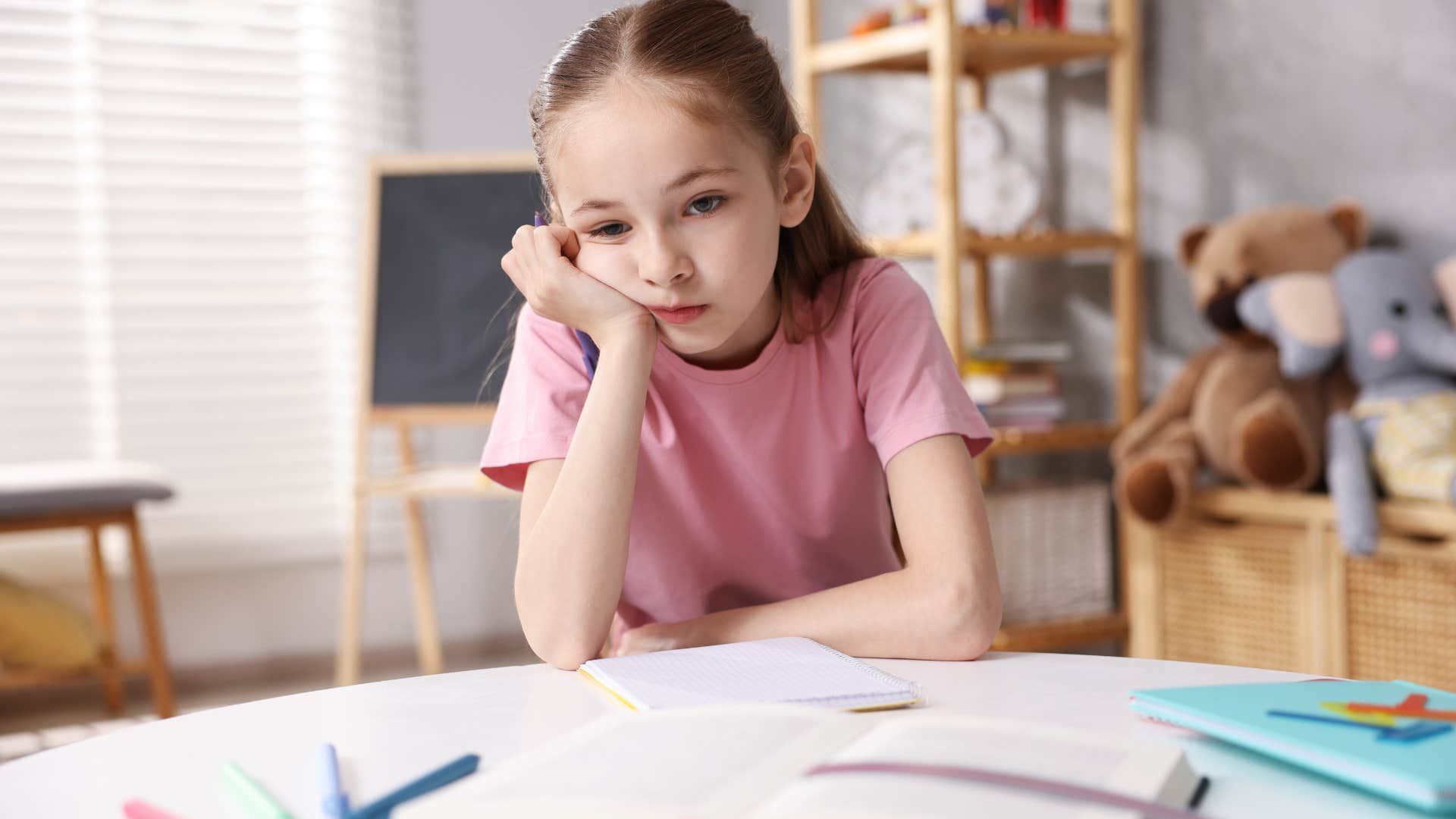 little girl upset at feeling ignored sitting alone