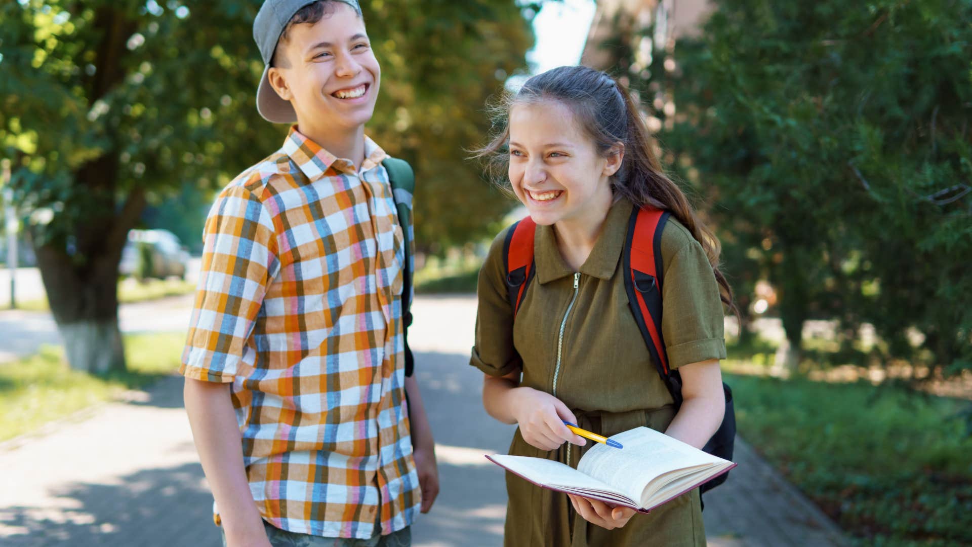 two teens sensitive to others emotions laughing together