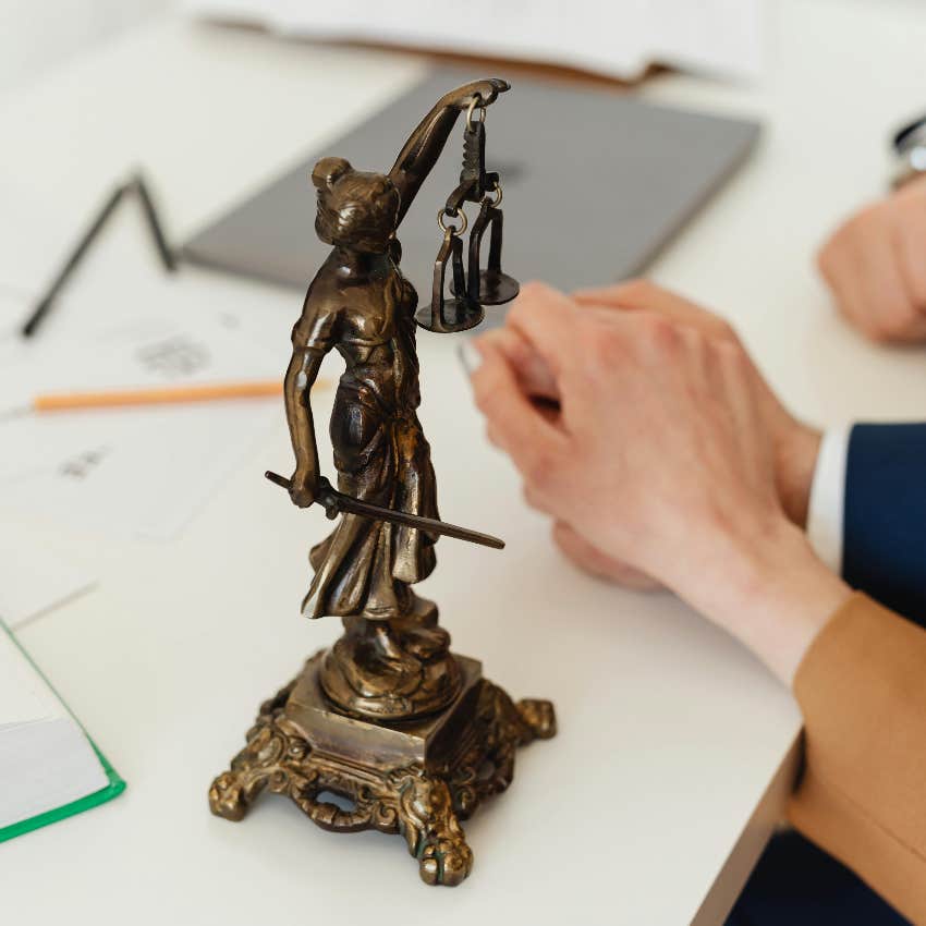 couple holding hands after being sued