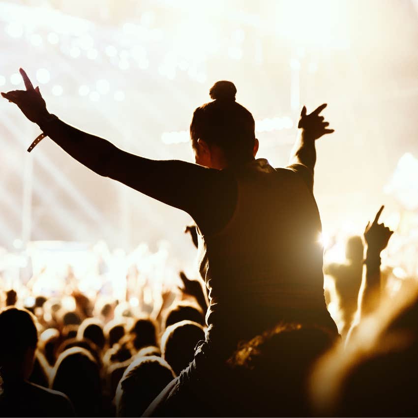 Young adult having fun at a concert that only rich can afford now