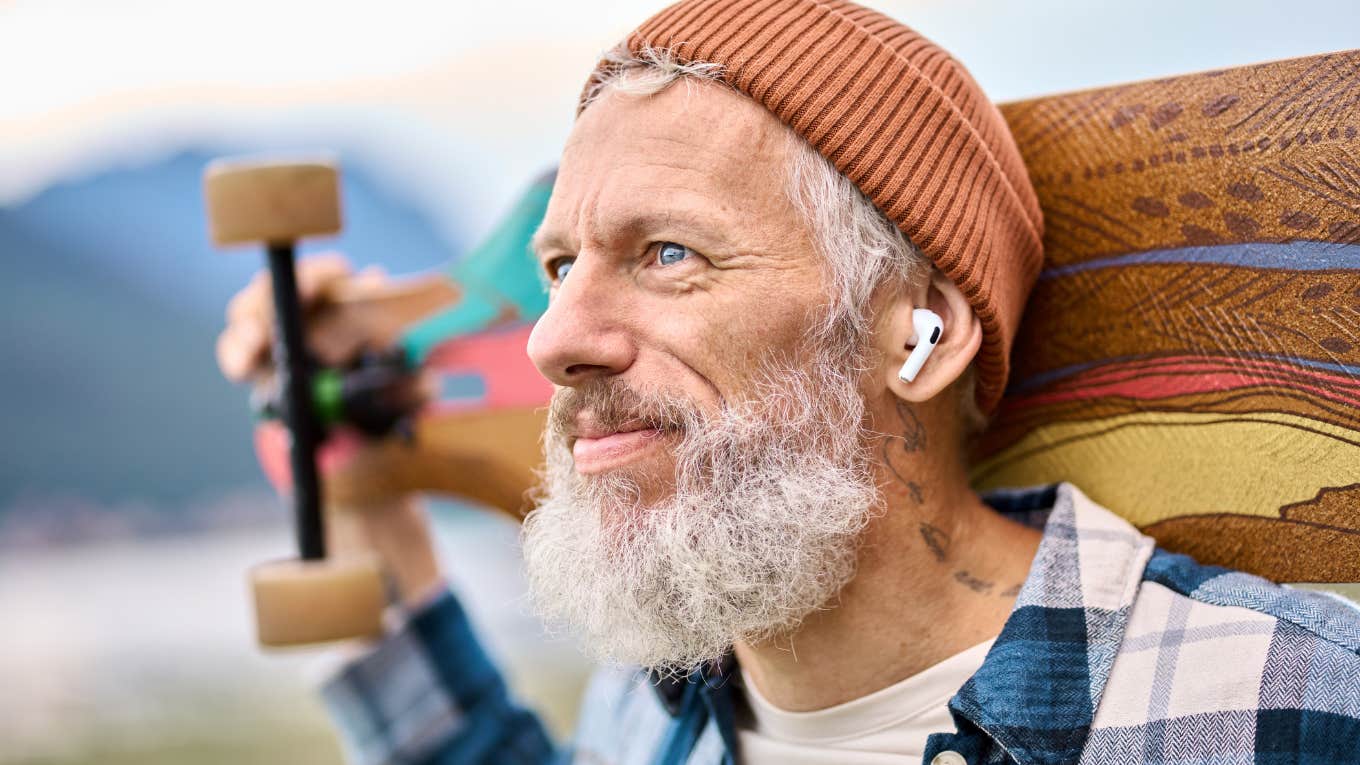 Boomer man who learned a lot form Gen Z holding skateboard