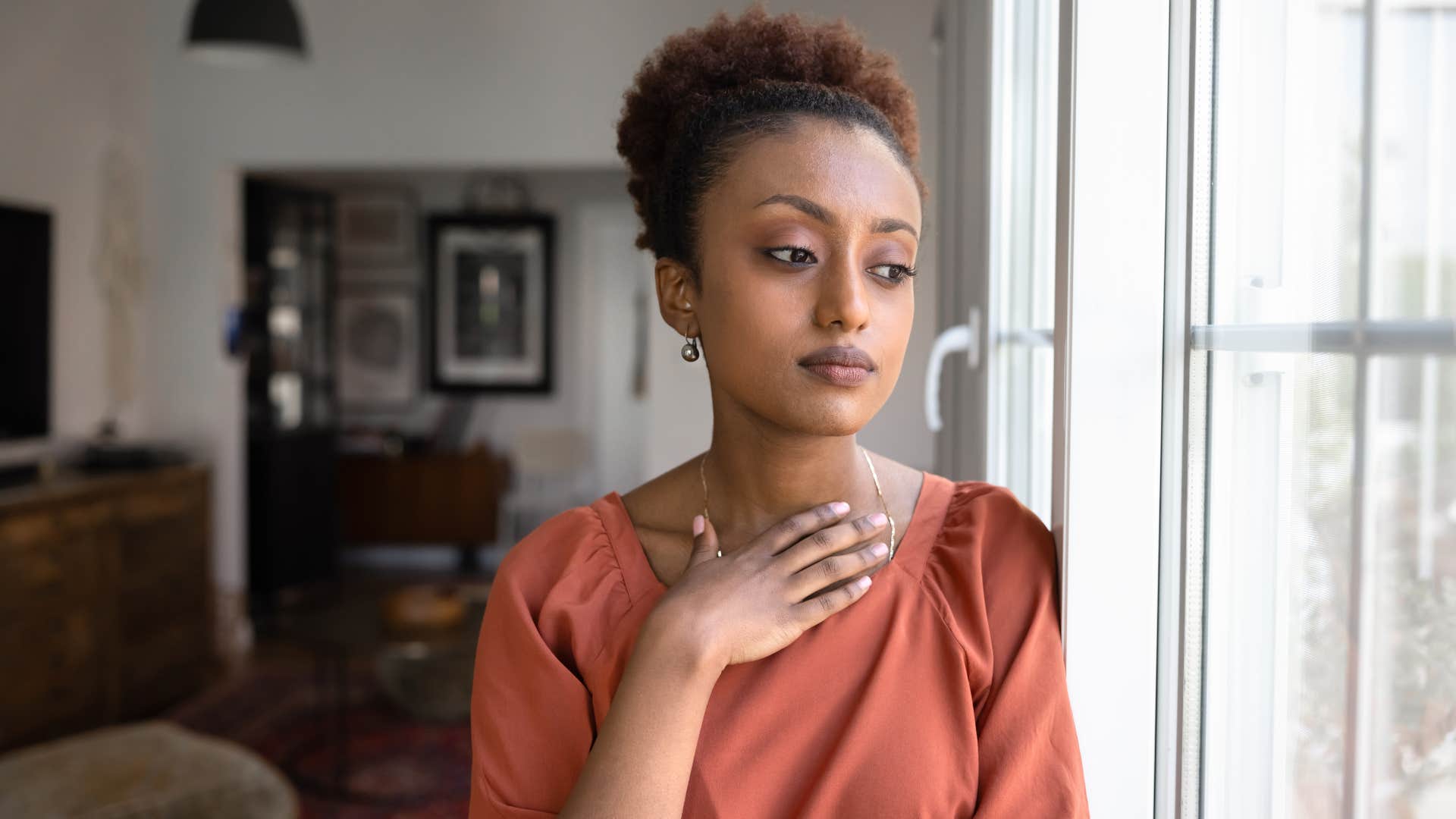 pensive woman under 50 realizing it's okay to outgrow things and people