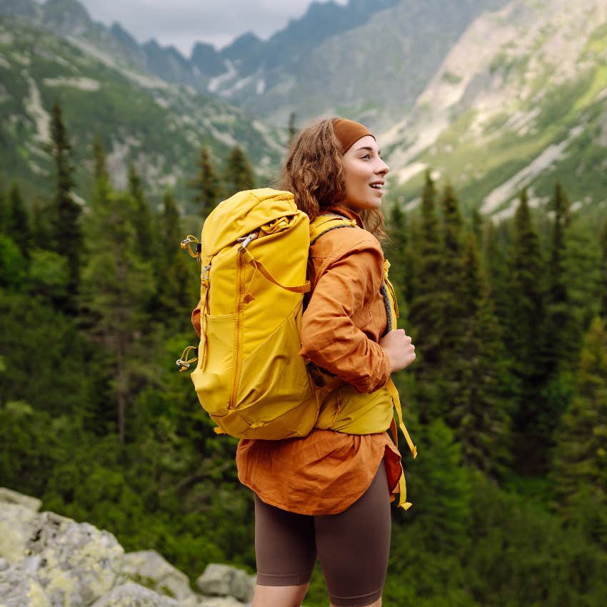woman feeling satisfied while hiking in the mountains