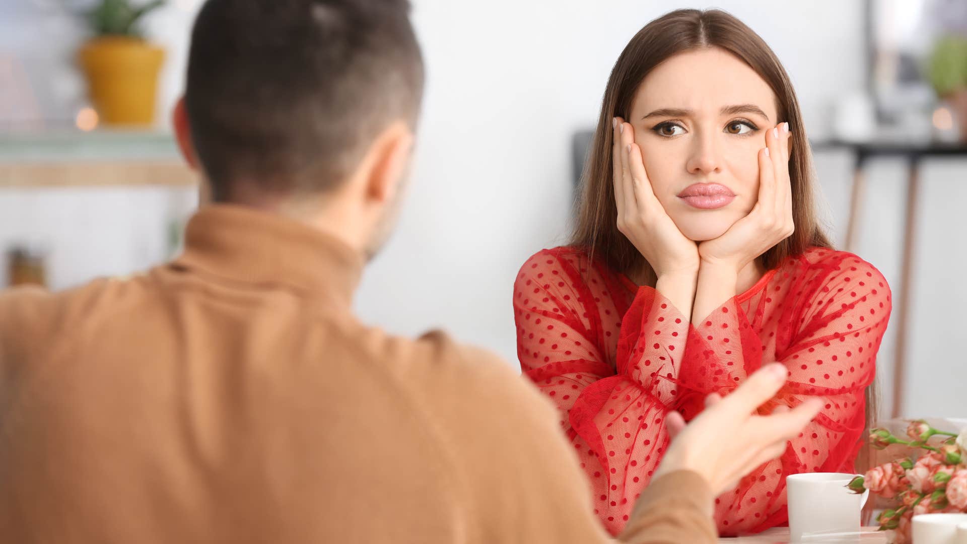 upset woman looking at man who won't defend her in public