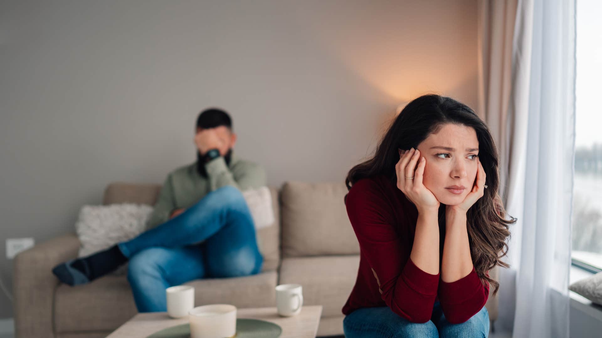 couple sitting apart after fight woman feeling lonely her partner breaks promises