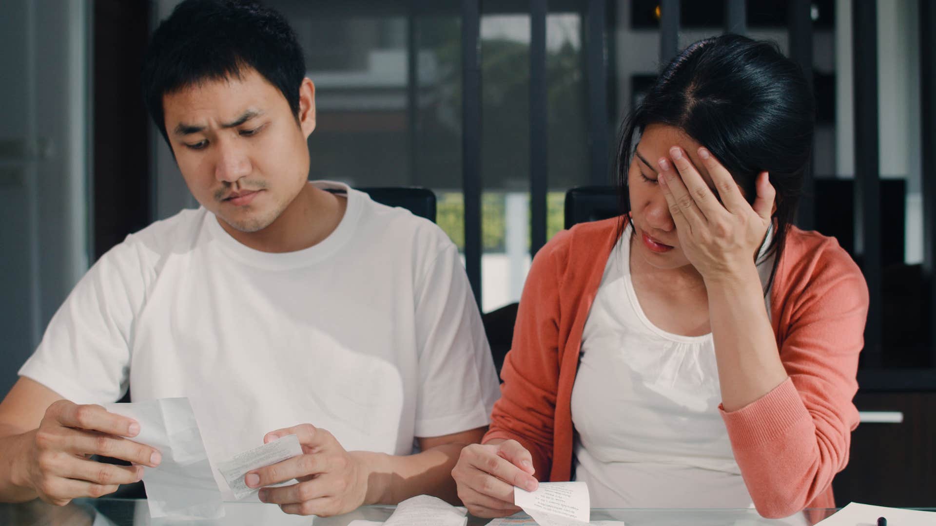 man hiding his finances while him and his wife do the bills