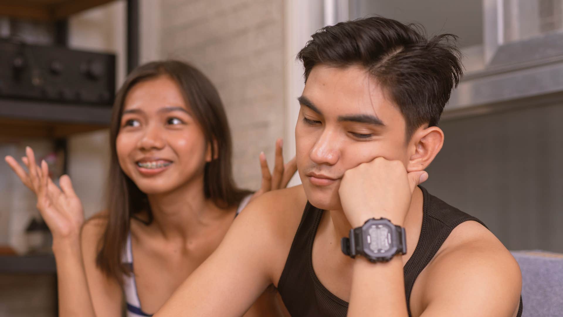 uninterested man who is cheating tuning out his partner while she talks