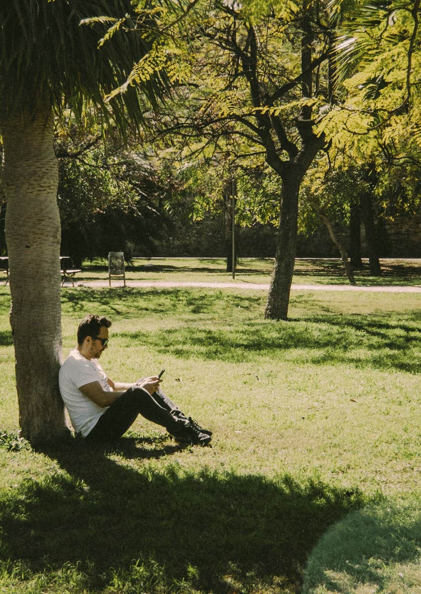 man calmly sitting alone at park