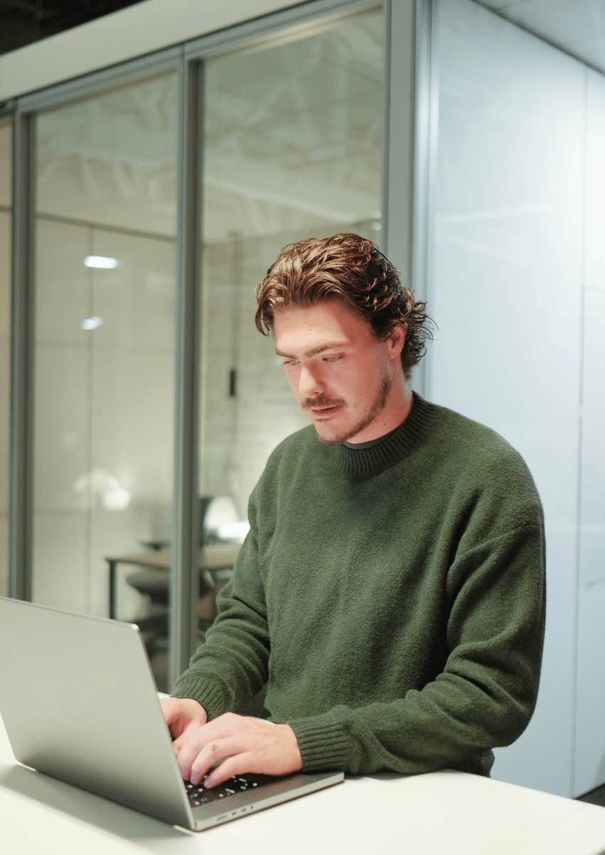 man focused working on laptop