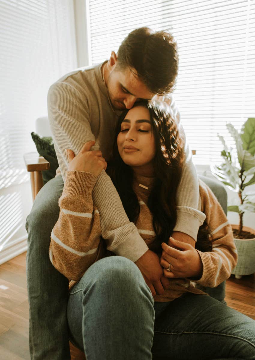 man hugging woman in comforting way