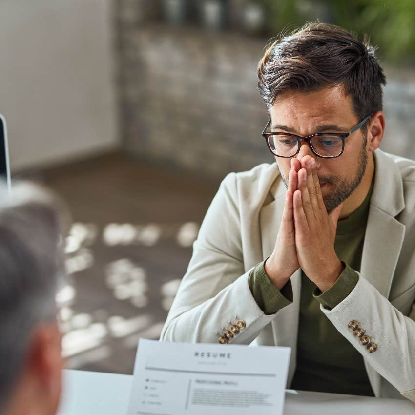 distraught young man sitting in job interview