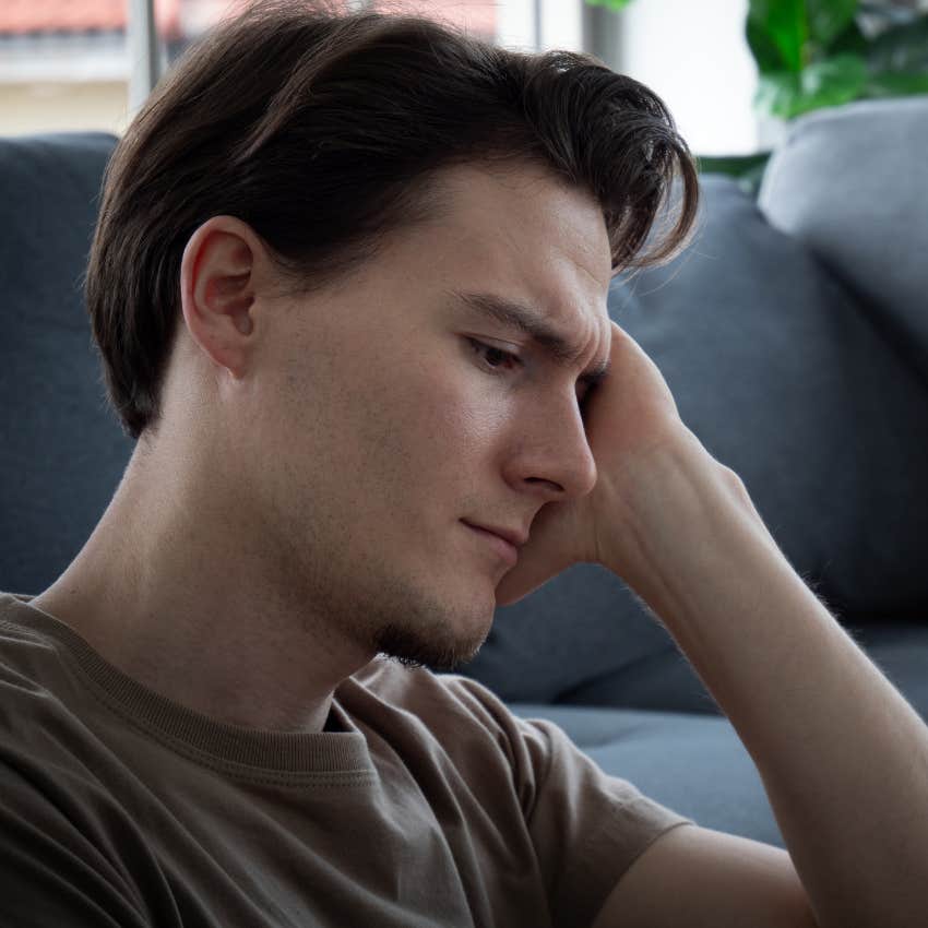 disappointed man sitting on floor at home
