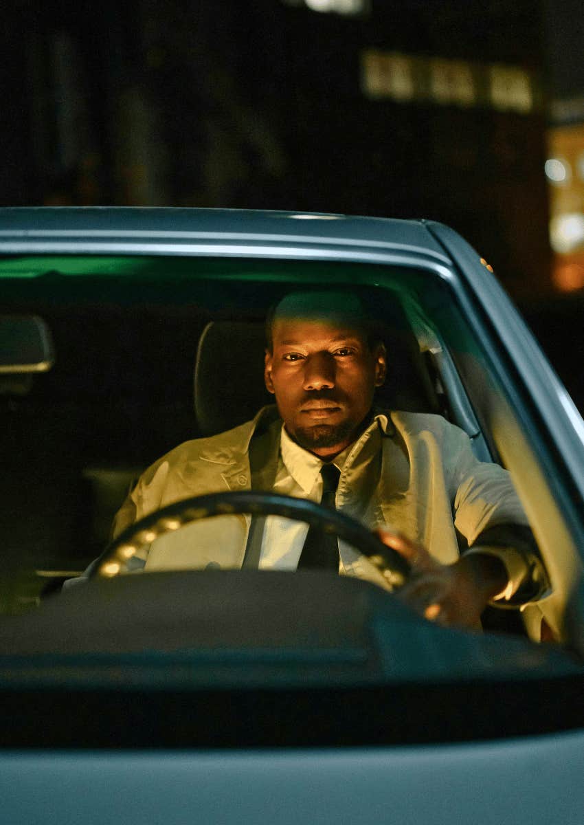 man sitting in his car alone