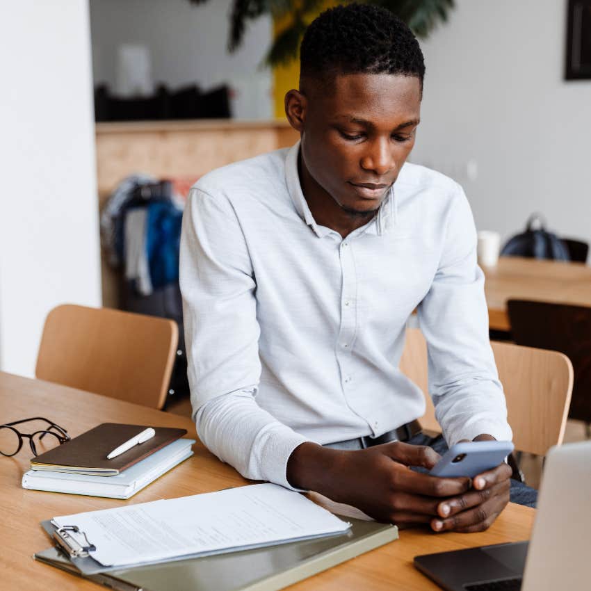 man with zero joy in life distracting himself with his phone
