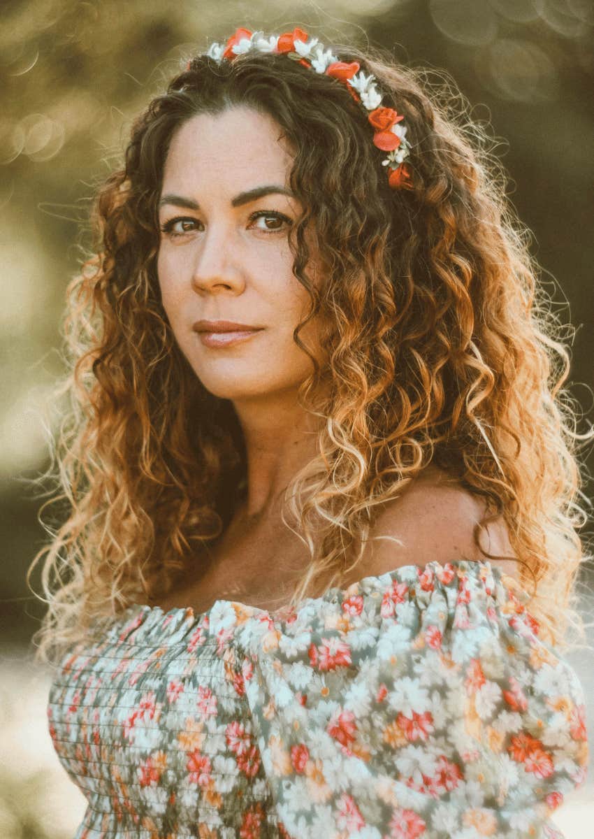 mature woman with long curly hair and blonde tips