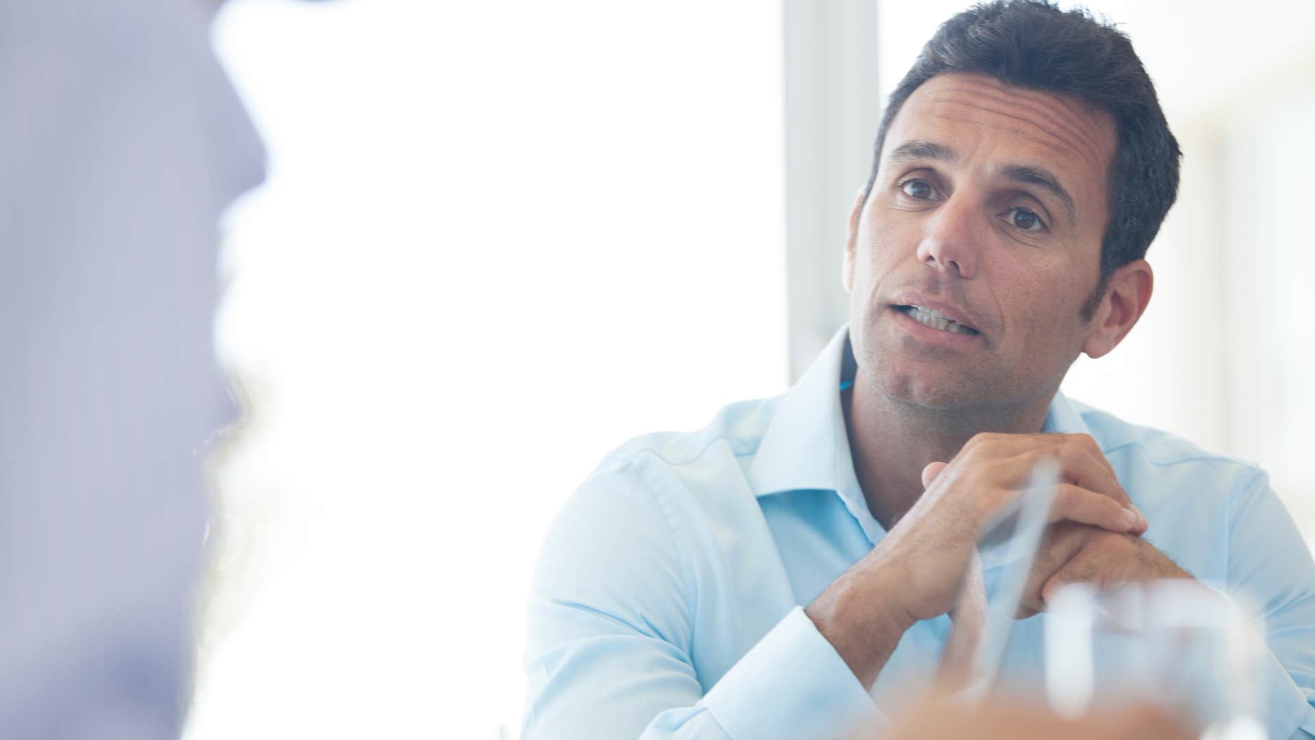 man who adapts quickly to the environment talking in a deep tone of voice to male friend