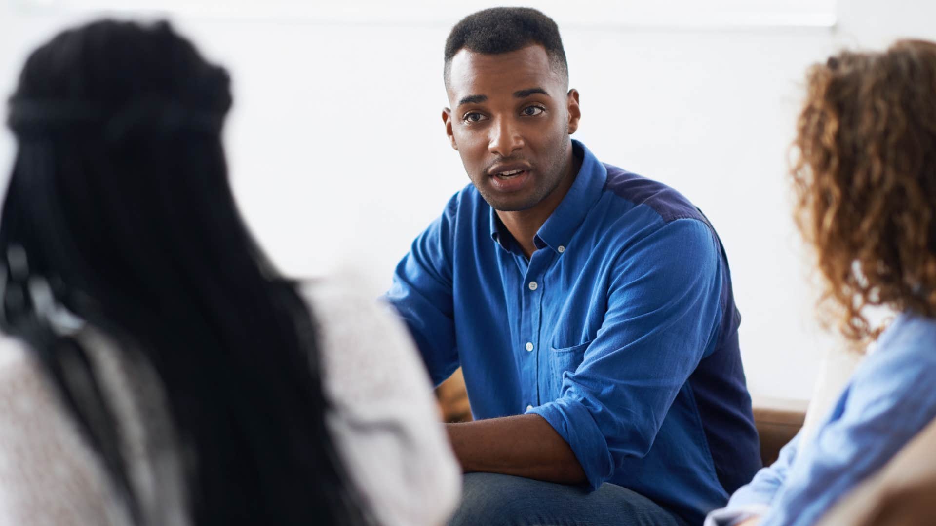 man attuned to social norms and structures sitting with his co-workers