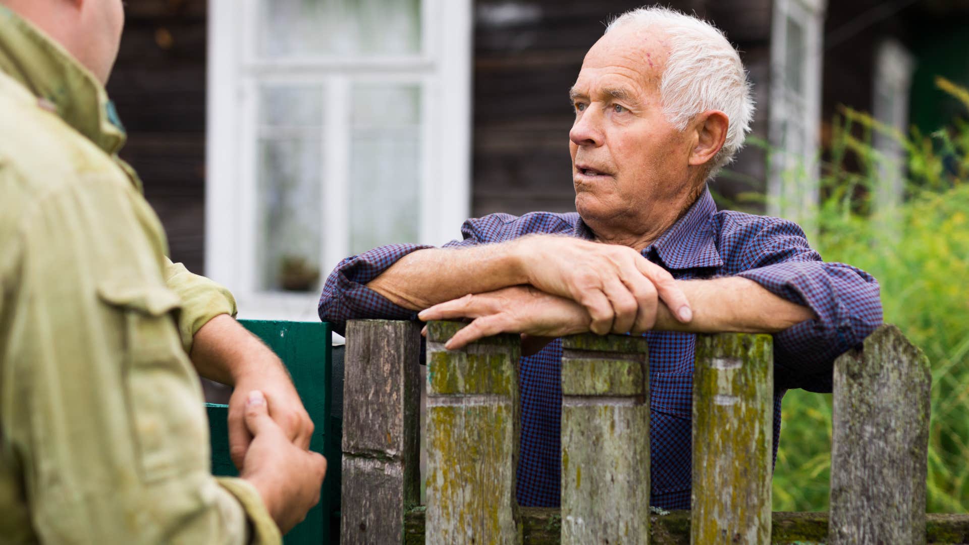 man staying calm amid discomfort talking to his neighbor