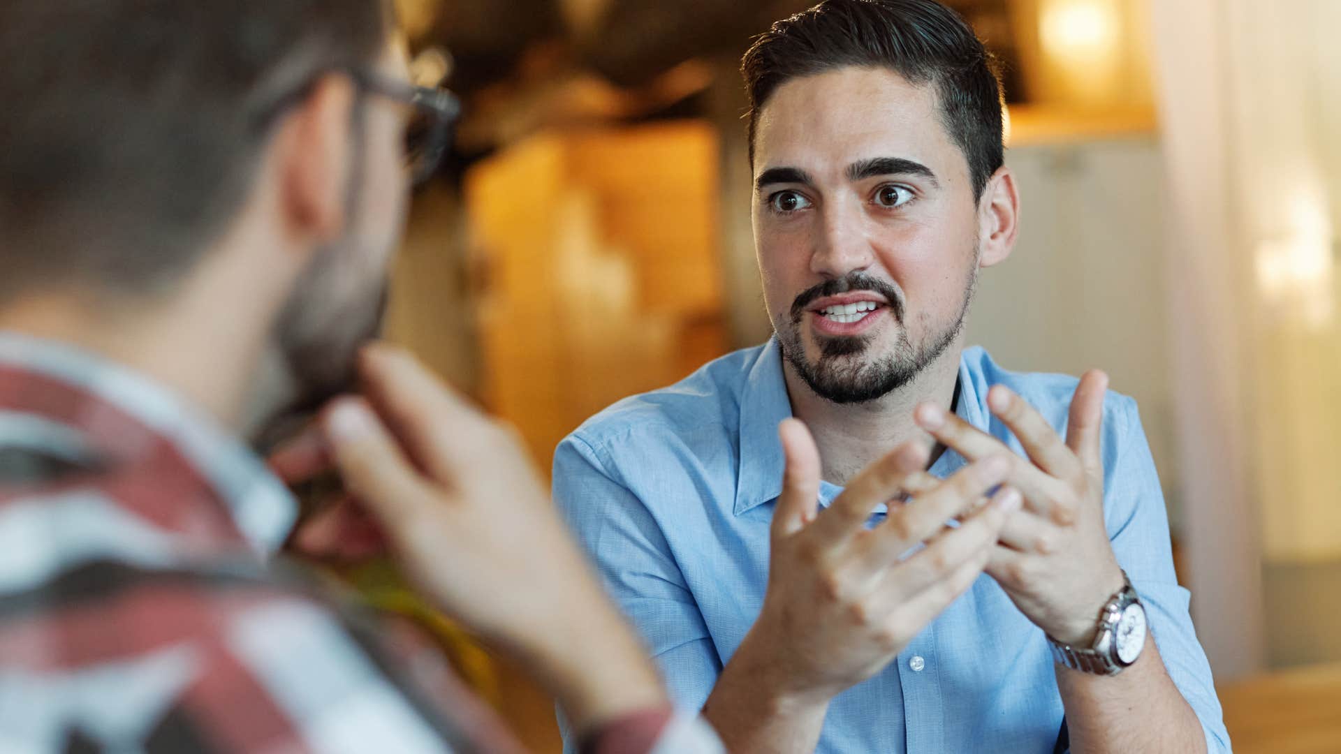 man practicing confidence with his guy friend