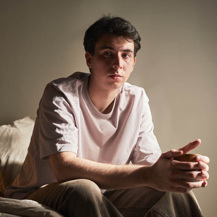 depressed former child prodigy sitting on bed