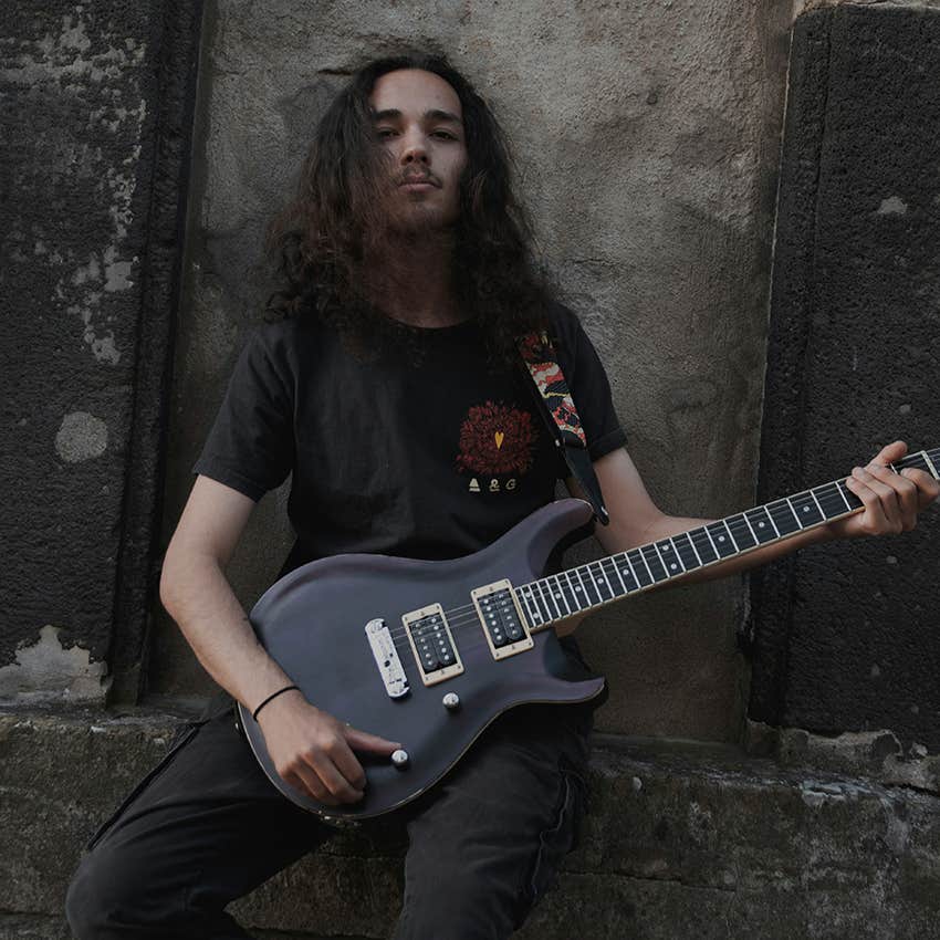 nordic man sitting with his electric guitar 