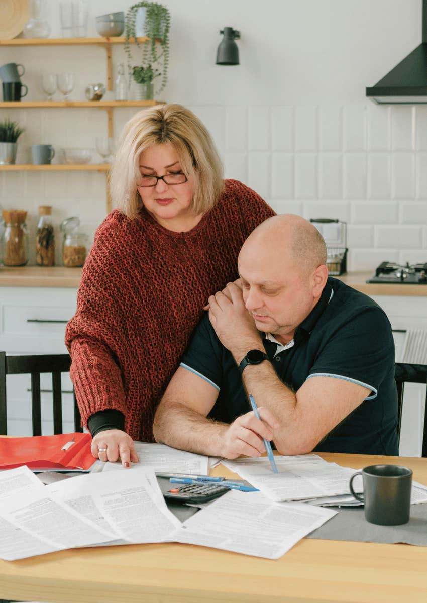middle age couple with no energy working through bills together