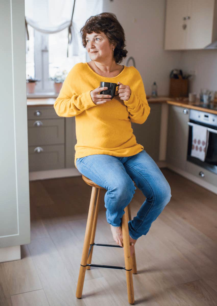 middle age empty nester drinking coffee alone