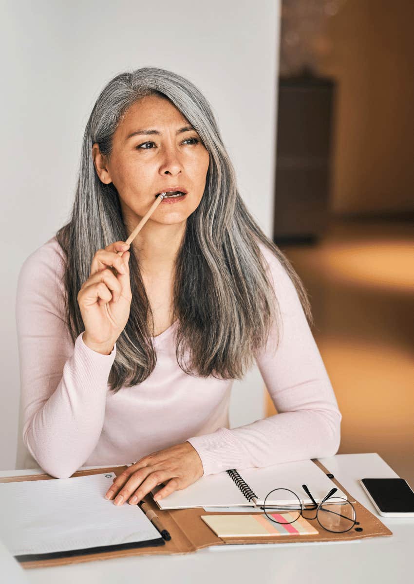 middle age woman maximizing her time by writing in journal