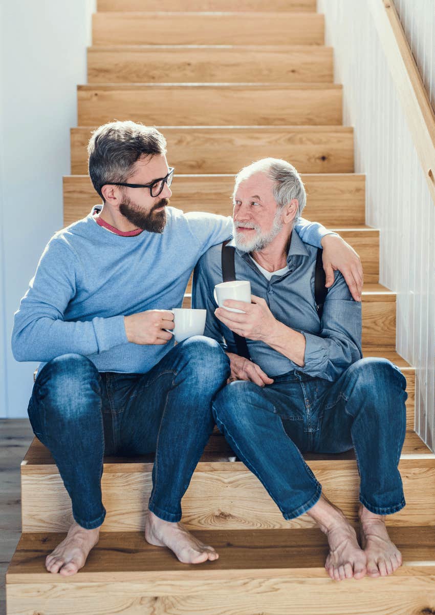 middle aged man hugging his elderly father