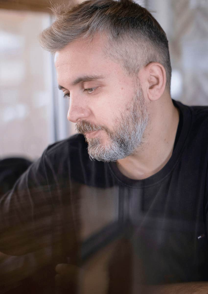middle aged man looking away with pensive expression