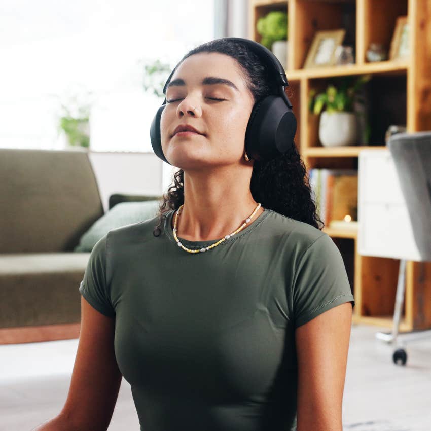 woman wearing headphones practicing mindfulness