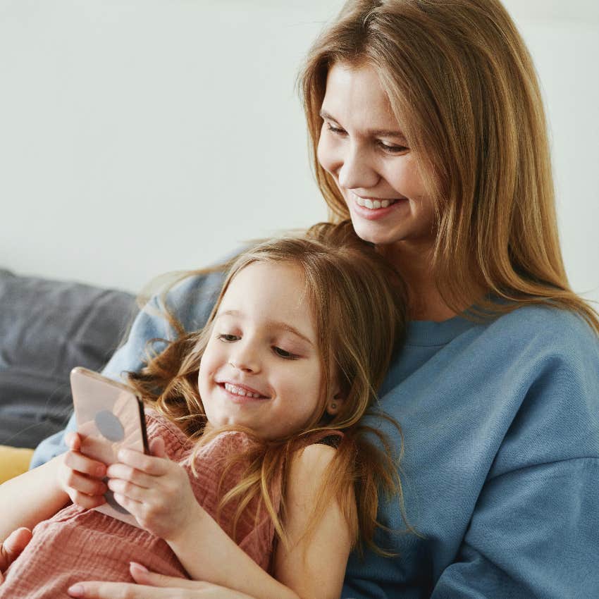 mom keeping her daughter safe by watching her phone usage