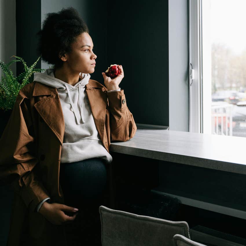 anxious mom looking out hospital window while in labor
