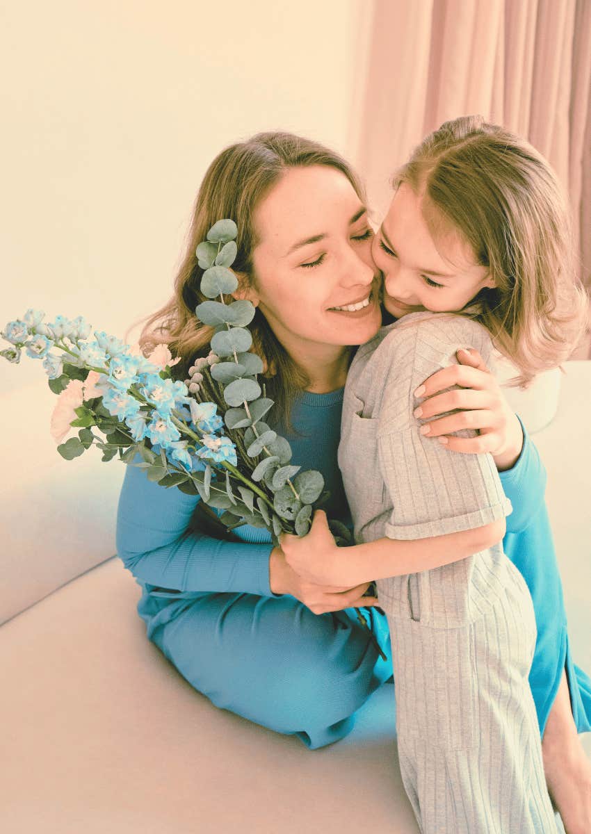 mom hugging her young daughter close