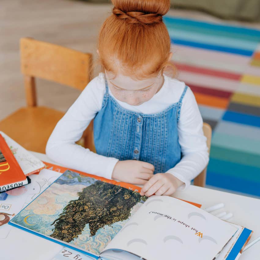 little girl reading for school