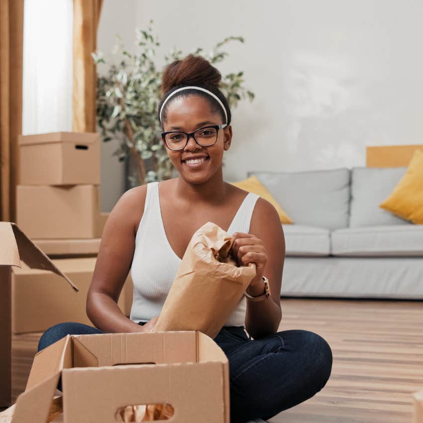 young woman unpacking without enough space for all her stuff